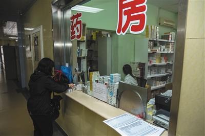 　4月8日，方庄卫生服务中心，一位患者正在药房取药，台面上摆着药品新旧价格对比表。