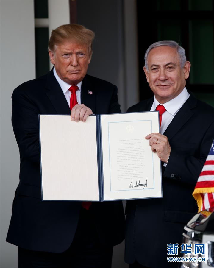 3月25日，在美国首都华盛顿白宫，美国总统特朗普（左）与以色列总理内塔尼亚胡展示特朗普签署的正式承认以色列对戈兰高地的主权的公告。