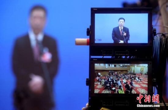 3月4日，全国政协十三届五次会议第一场“委员通道”采访活动在北京人民大会堂新闻发布厅举行。图为分会场摄像机显示屏显示的主会场与分会场画面。 中新社记者 张宇 摄