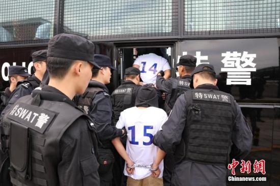 资料图：5月29日，黑龙江省警方押解124名“5.6”特大系列电信诈骗案犯罪嫌疑人抵达哈尔滨，该诈骗团伙涉案金额达7000余万元、被害人遍布全国10余个省(直辖市)。中新社记者
